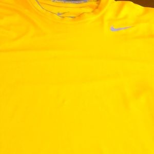 Nike short sleeve dri fit gold workout shirt.